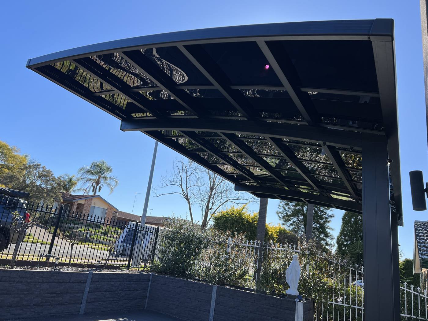 Curved Cantilever Carport installation Sydney — Sword Sky outdoor structure installer